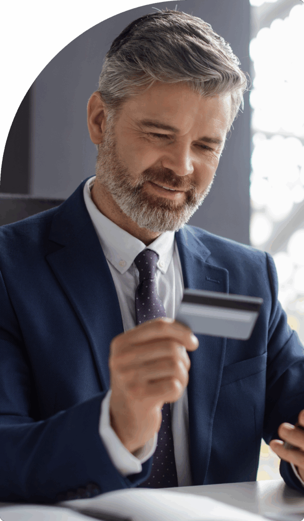 Businessman in suit holding a card – professional financial services and card solutions in Dubai