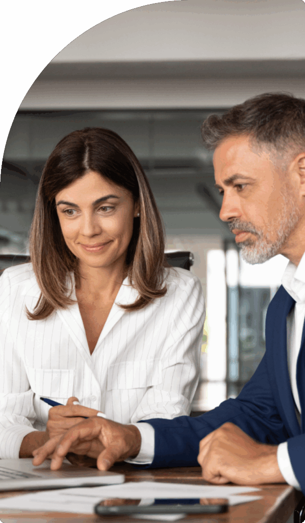 Two business professionals discussing steps to open a corporate bank account in Dubai.