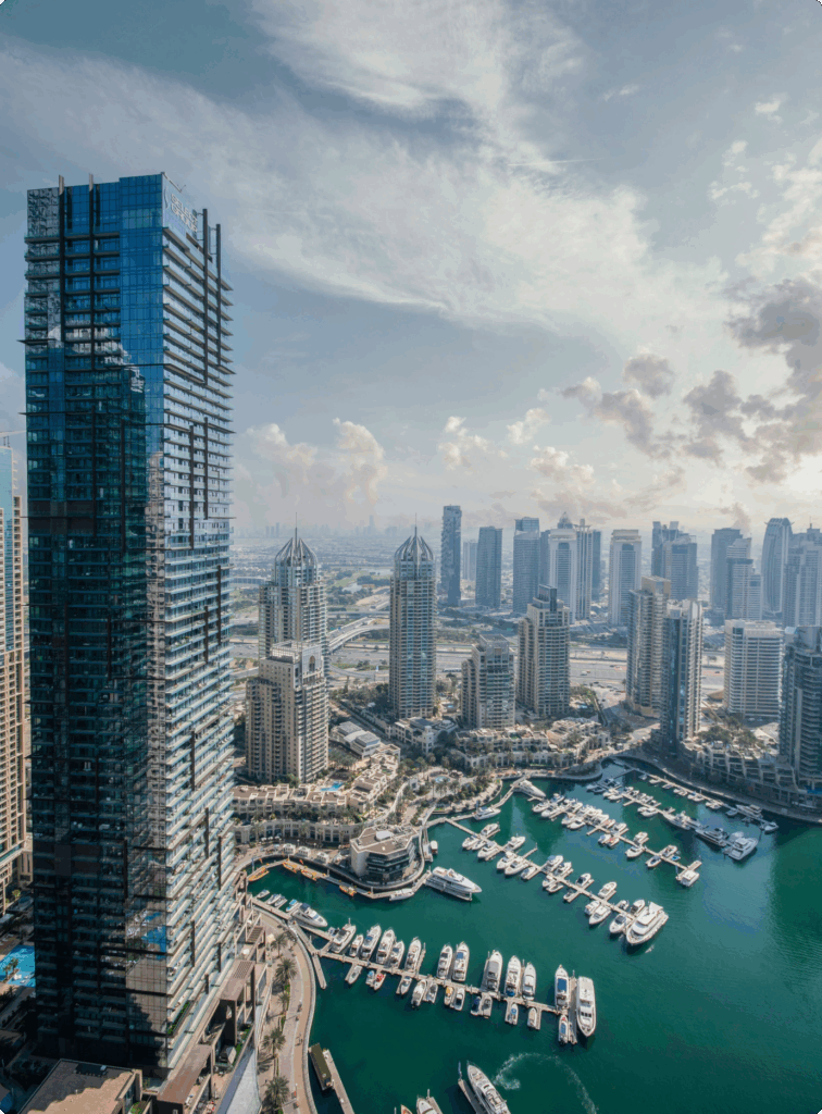 Aerial view of Dubai Marina skyline with yachts and towers, ideal for relocation lifestyle appeal.