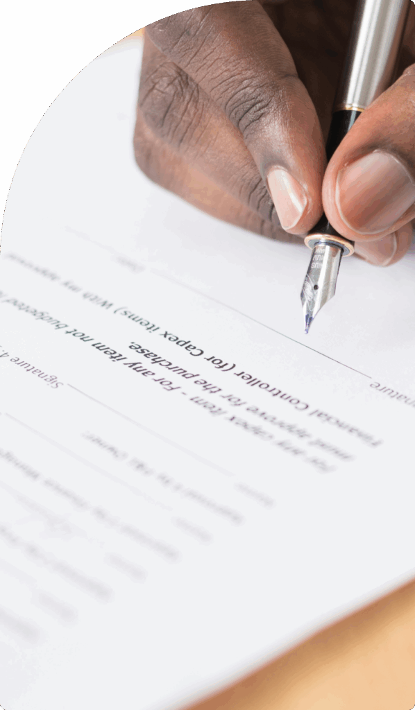 Close-up of hand signing a legal contract with a fountain pen, symbolising legal services in Dubai.