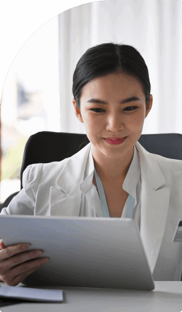 Businesswoman in Dubai reviewing documents on a tablet for accurate VAT compliance procedures