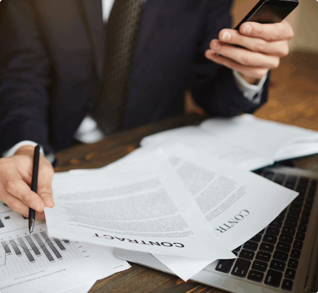 Businessman reviewing financial documents and graphs, illustrating VAT compliance process in Dubai.