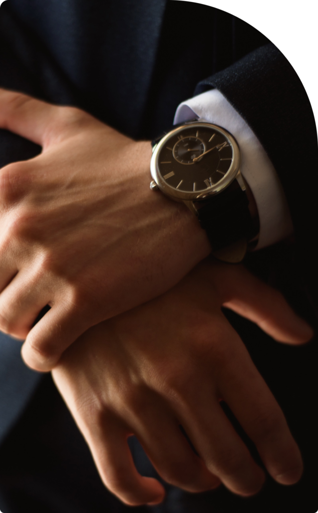 A close-up of a successful entrepreneur in an elegant suit wearing a luxury watch, symbolizing prestige, time management, and high-net-worth business leadership in Dubai.