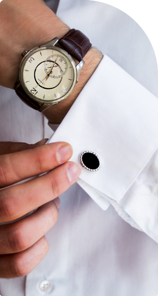 A close-up of a businessman adjusting his cufflinks and wearing a luxury watch, symbolizing prestige, professionalism, and high-net-worth success in Dubai.