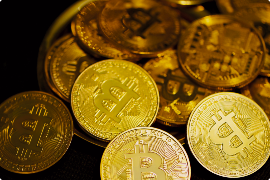 A collection of gold Bitcoin coins representing cryptocurrency investments, blockchain innovation, and Dubai’s VARA-regulated digital asset market.