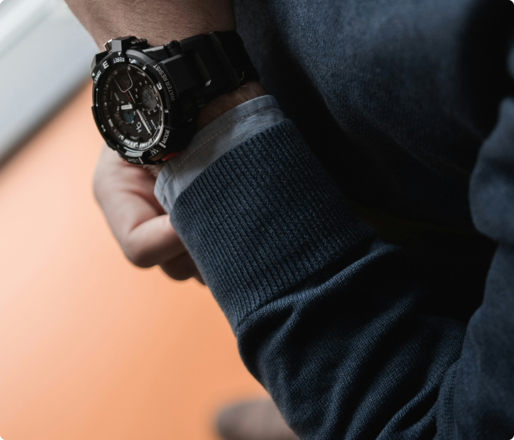 A close-up of a high-net-worth individual wearing a luxury watch, symbolizing prestige, time management, and business success in Dubai.