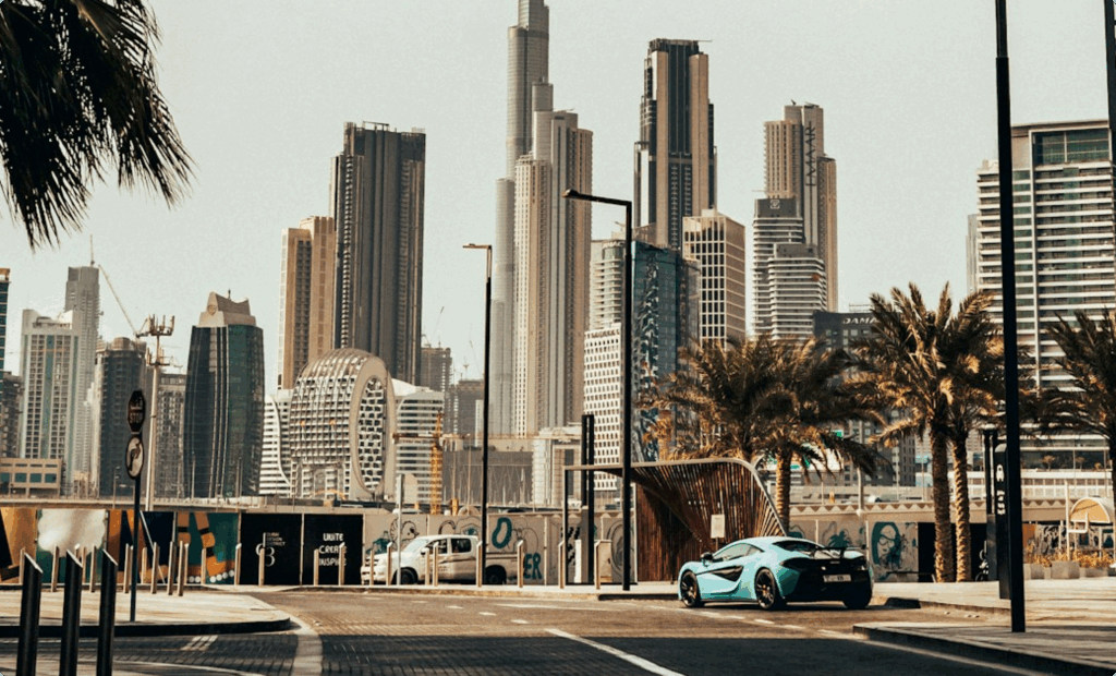 Street view of Dubai’s futuristic skyline with luxury car, symbolising prosperity and appeal of UAE free zones for businesses