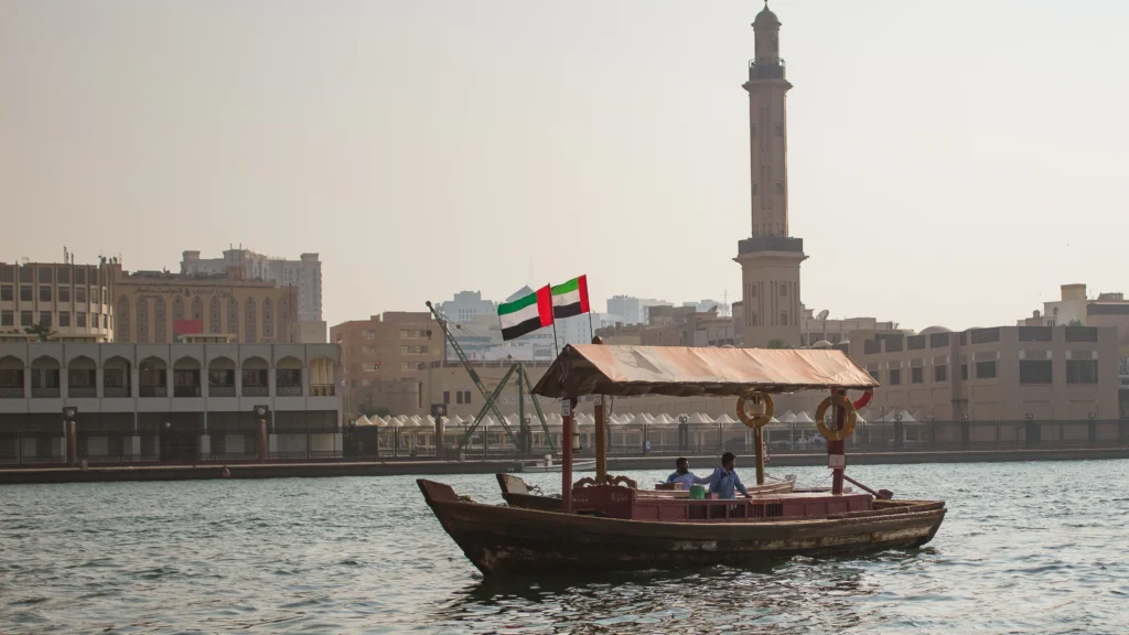a view of a boat on water with the UAE flag on top