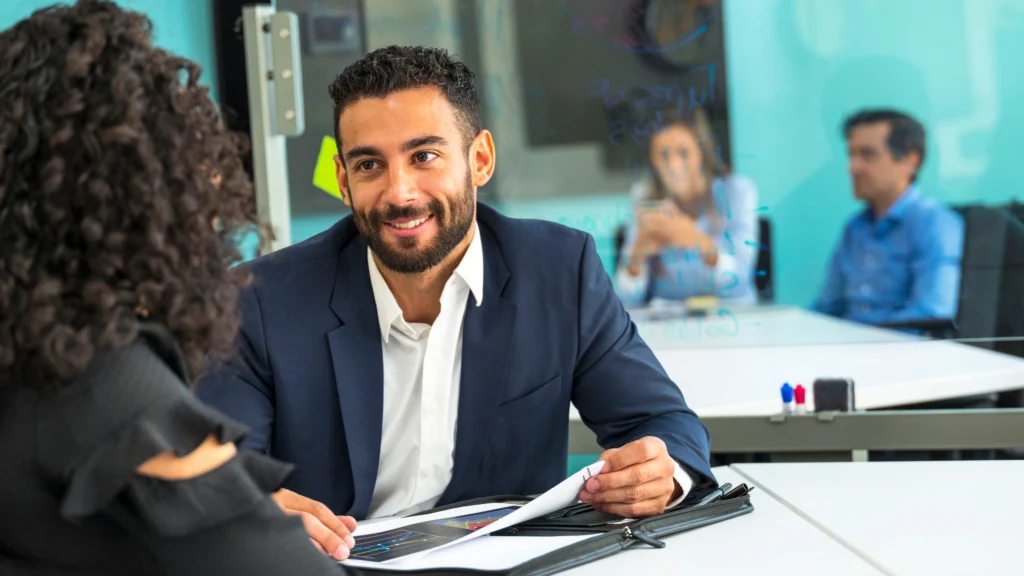 a man meeting with a client and advising her about something