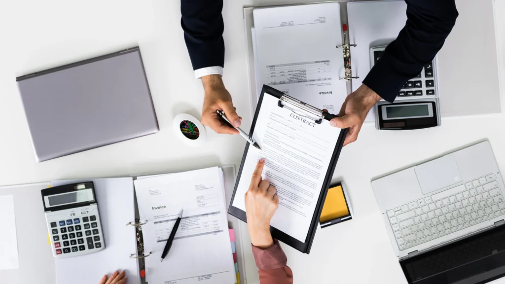 one person holding a contract while the other reads through it