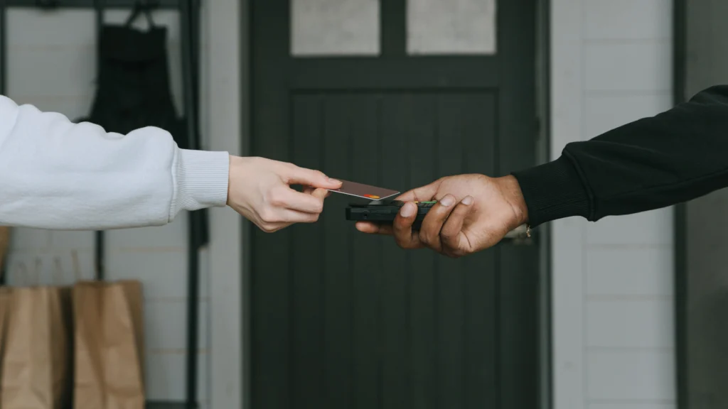 man paying a fee to another man