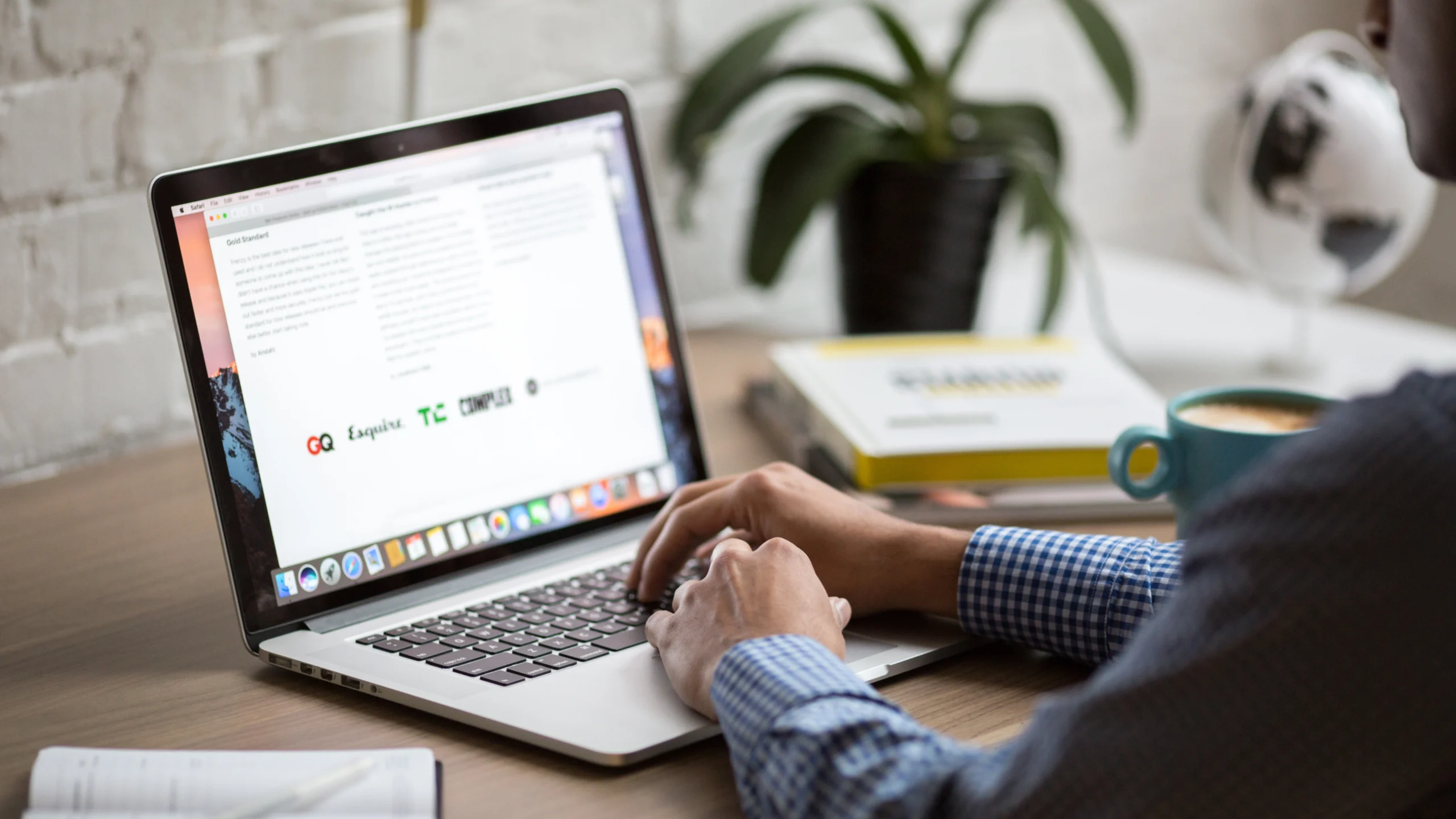 man using his laptop to go over a website