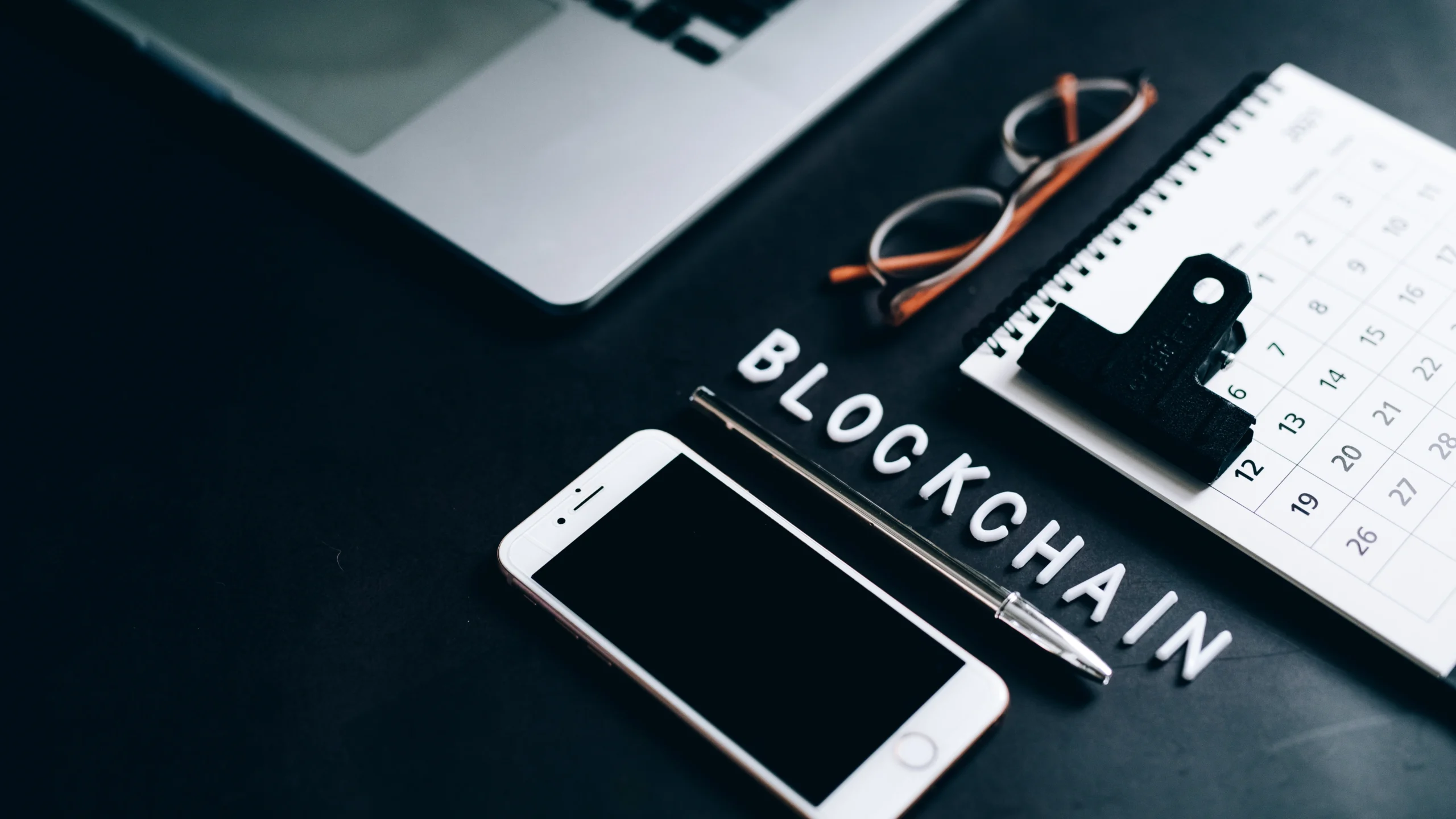 table with letters that spell out blockchain and important items