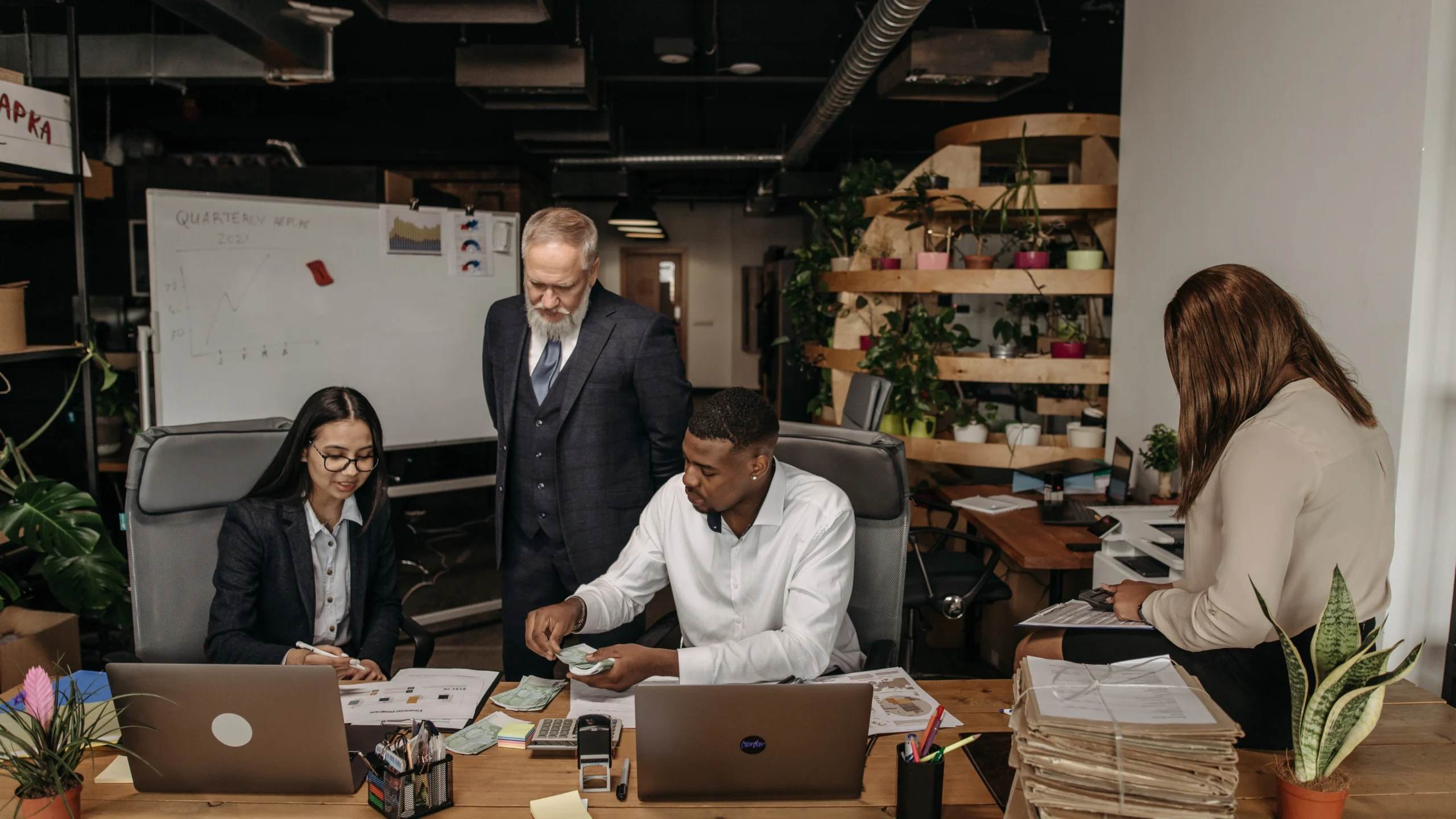 people in an office environment with a manager overseeing them