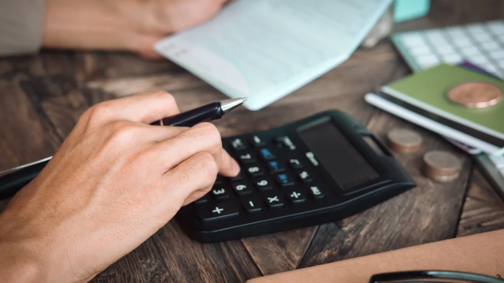 person using a calculator to go over financing