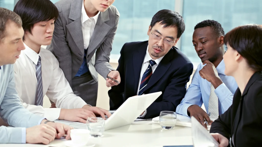 a diverse group of professionals in the UAE going over documents