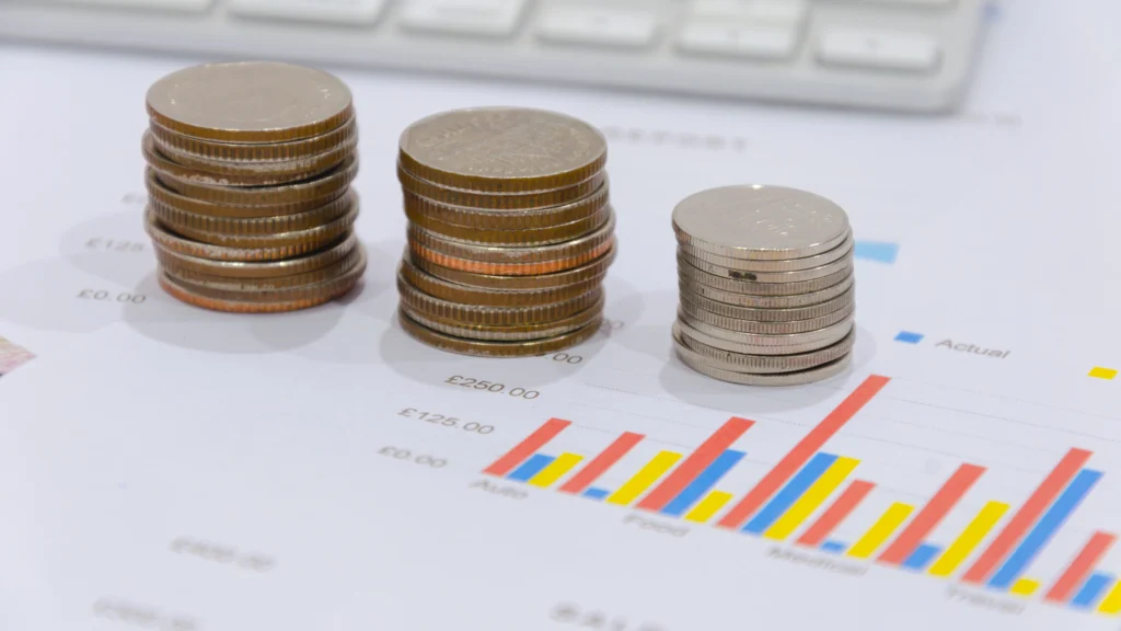 a stack of coins on top of important papers