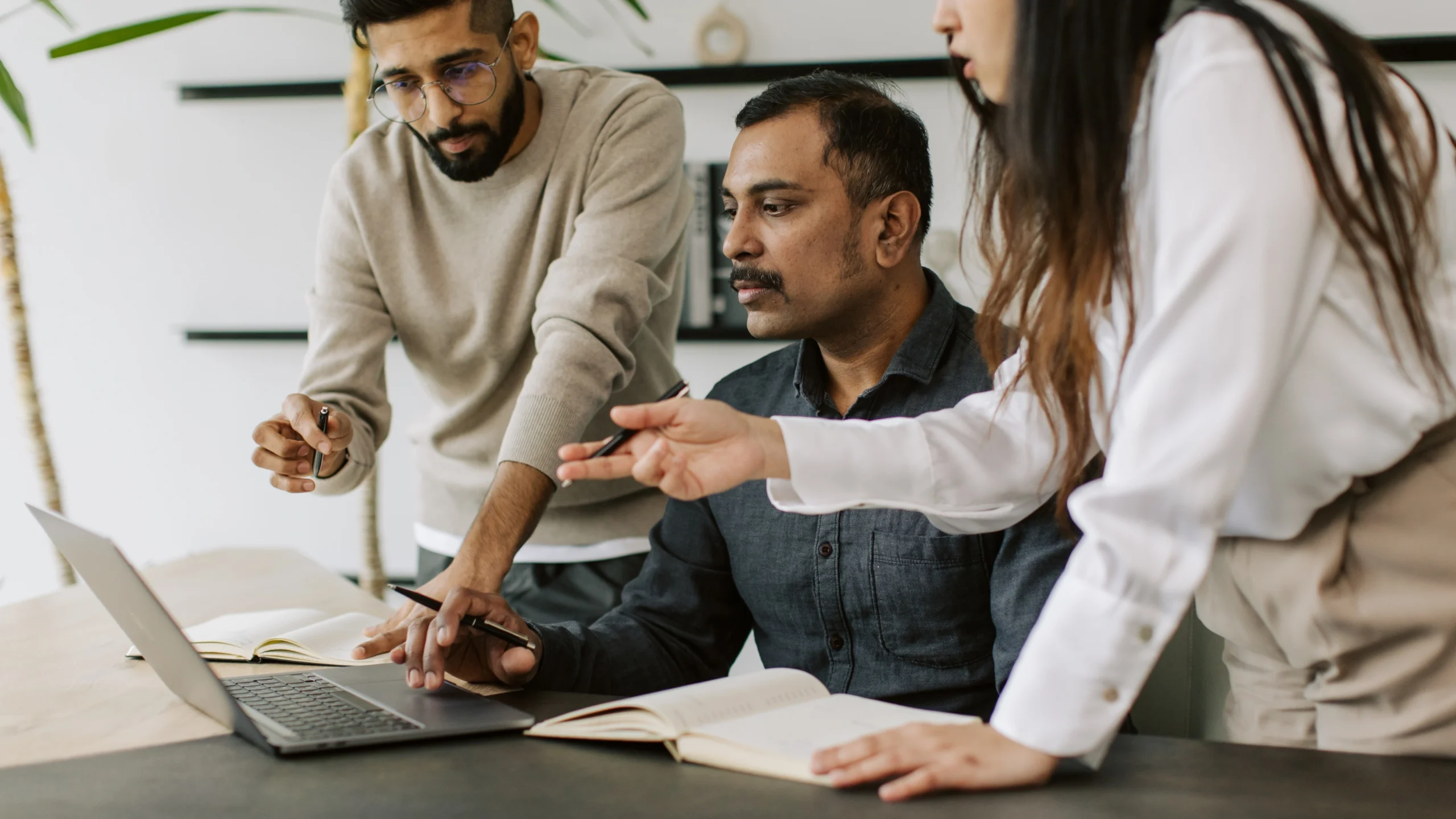 two men and a woman figuring out their plan about work
