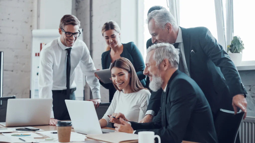 a group of workers gathered around a desk