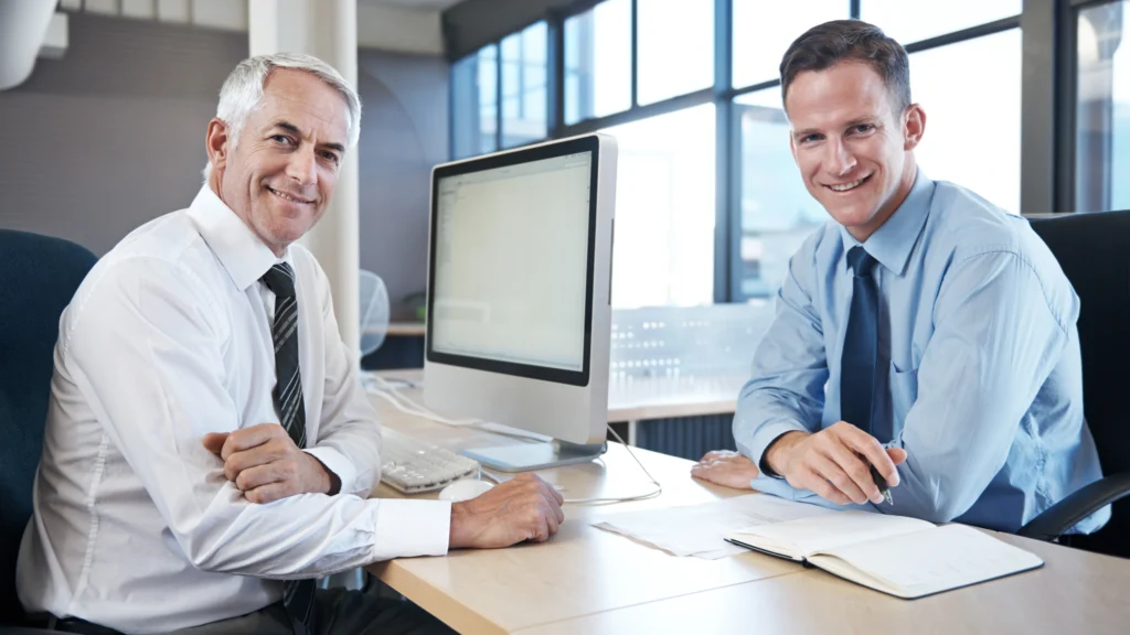 two businessmen smiling for a picture after their meeting