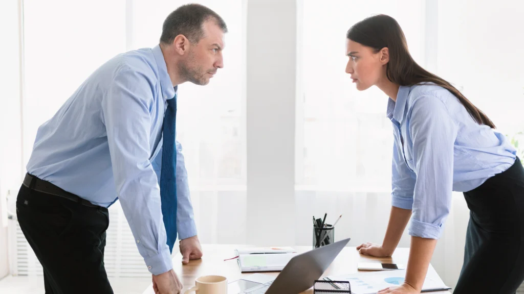 Two people confronting each other about problems related to work