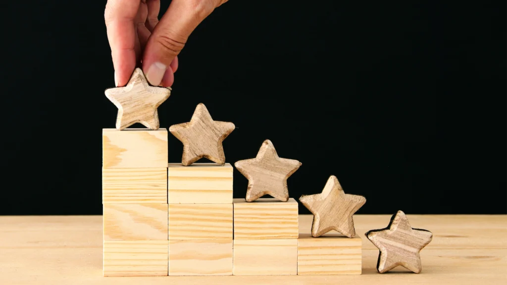 a person setting up building blocks as a ranking