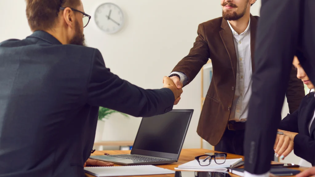 two men engaging in business and shaking hands