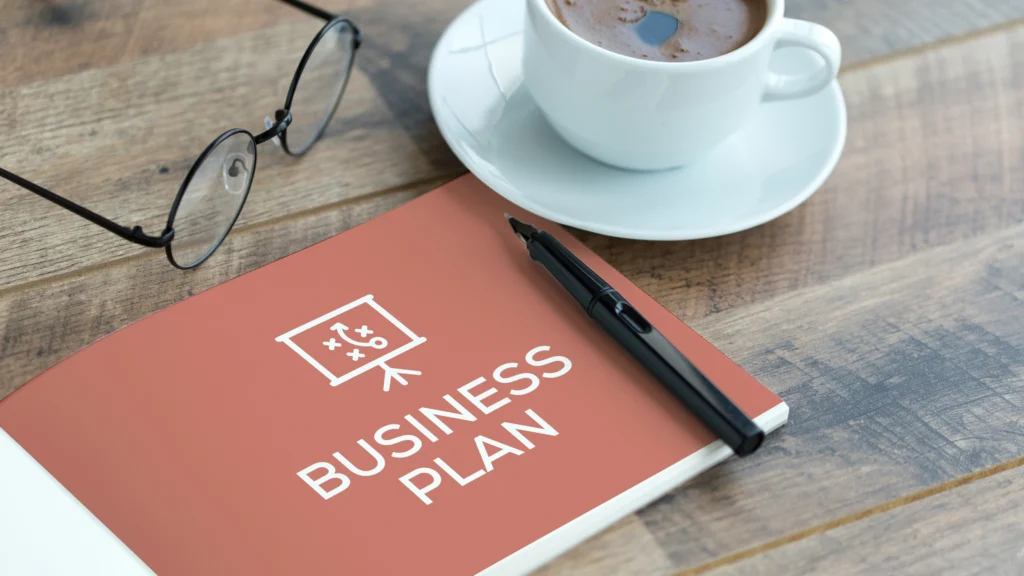 a large book that says business plan on the cover