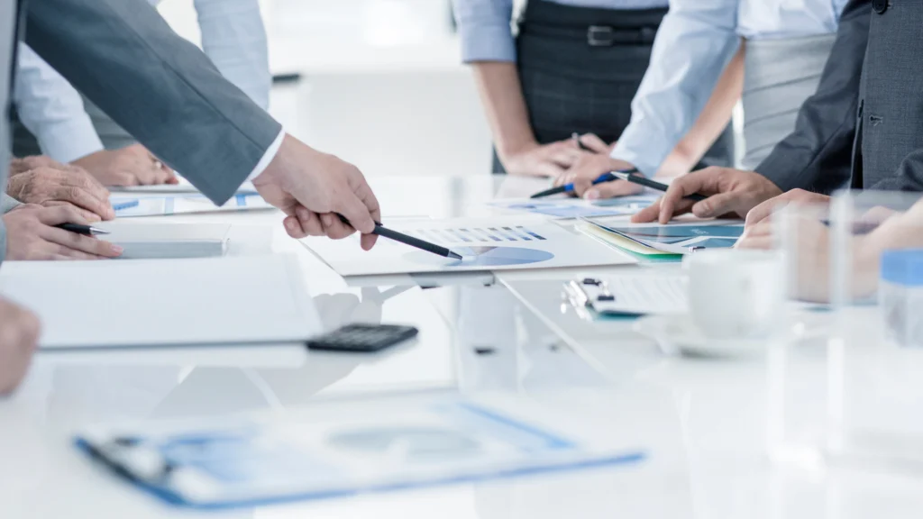 a person clearing up details about business with other people in the office