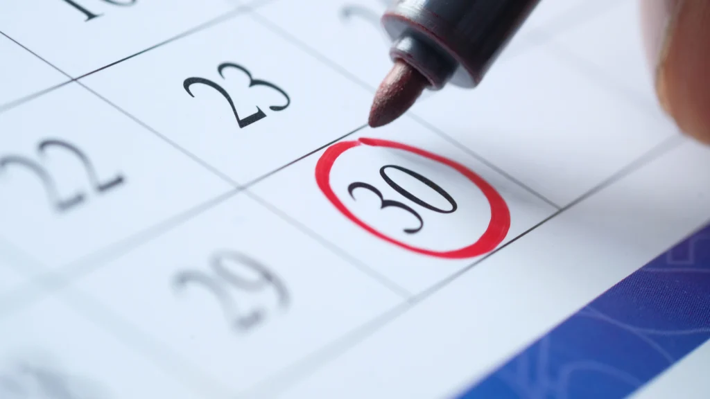 person marking their calendar for something important