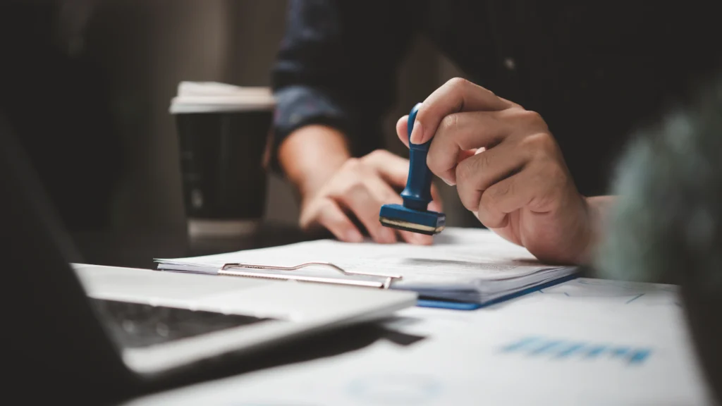 man stamping his signature on an important document