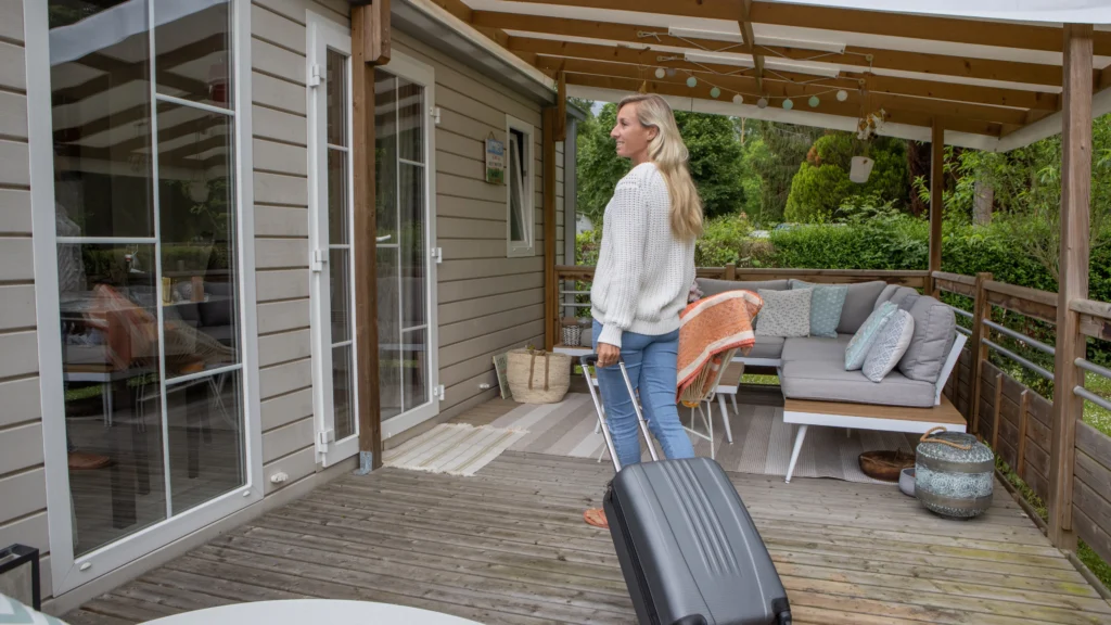 woman moving into housing with her luggage