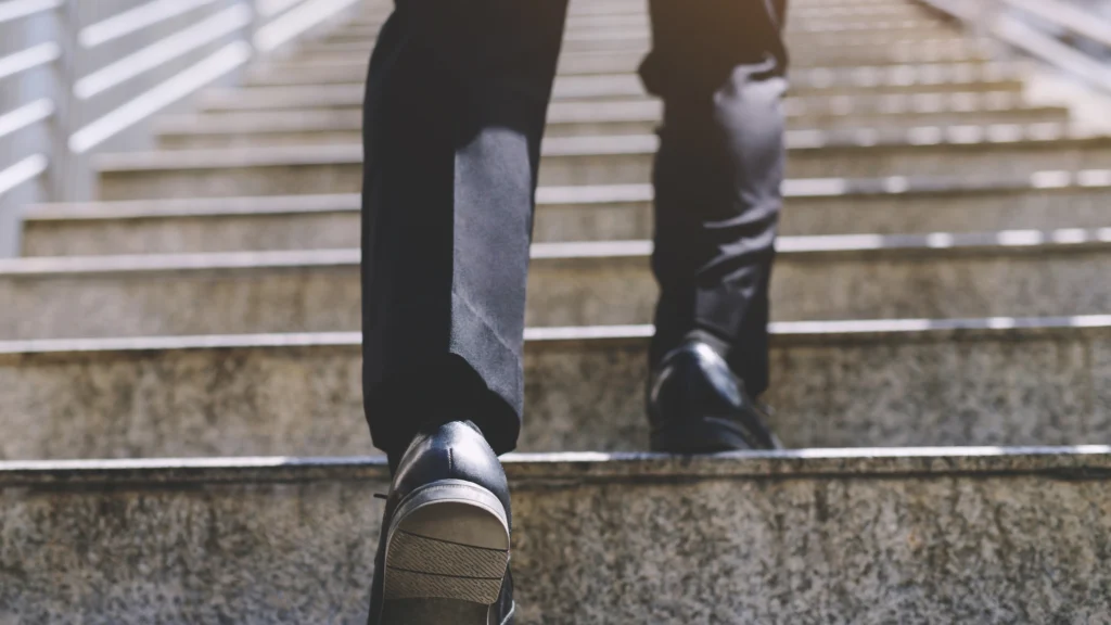 a man walking up steps to get to his workplace