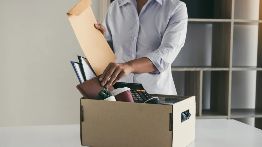 a businessman packing everything in his office to leave work
