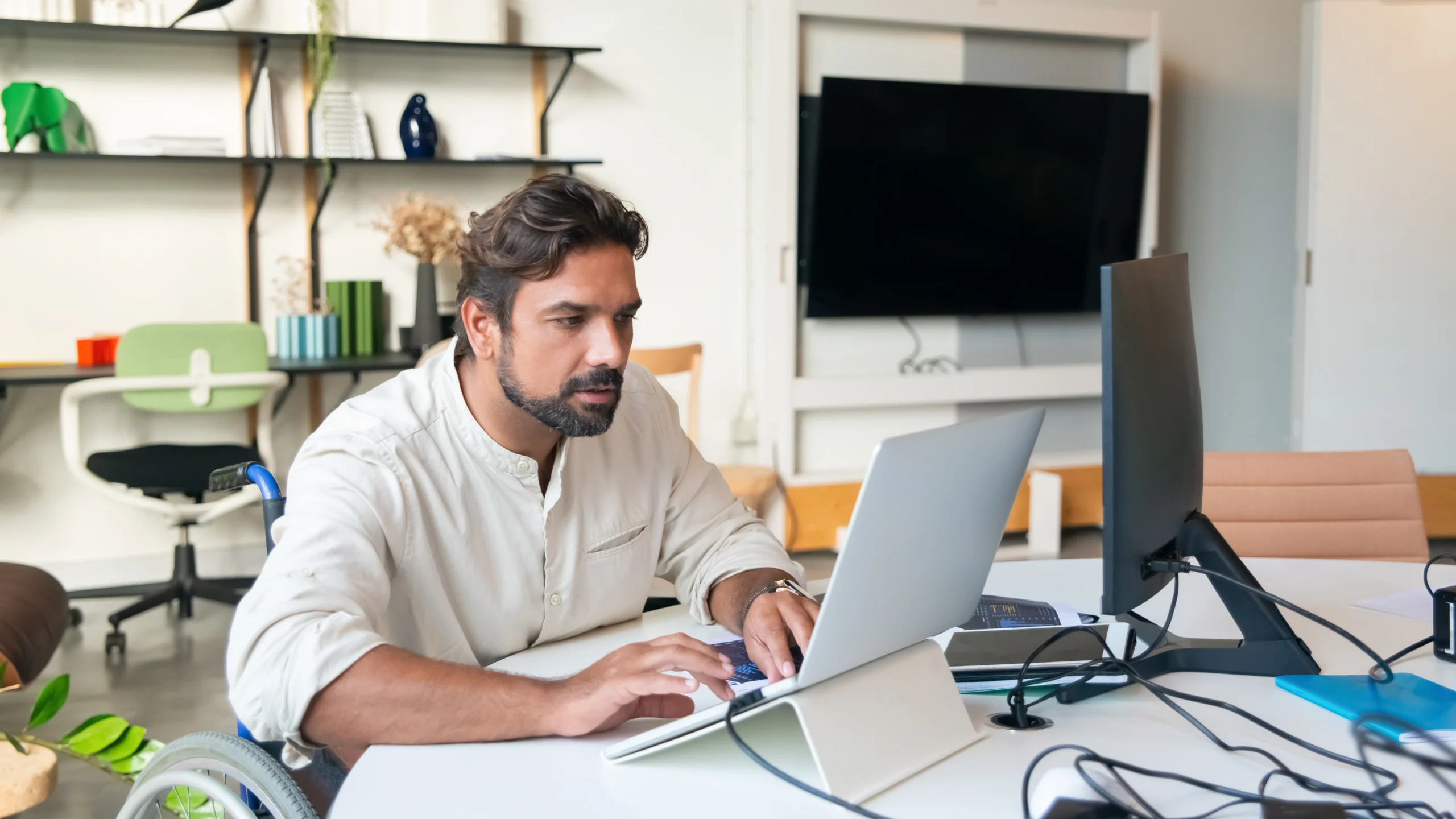 a man sitting at a desk in his home and working a remote job
