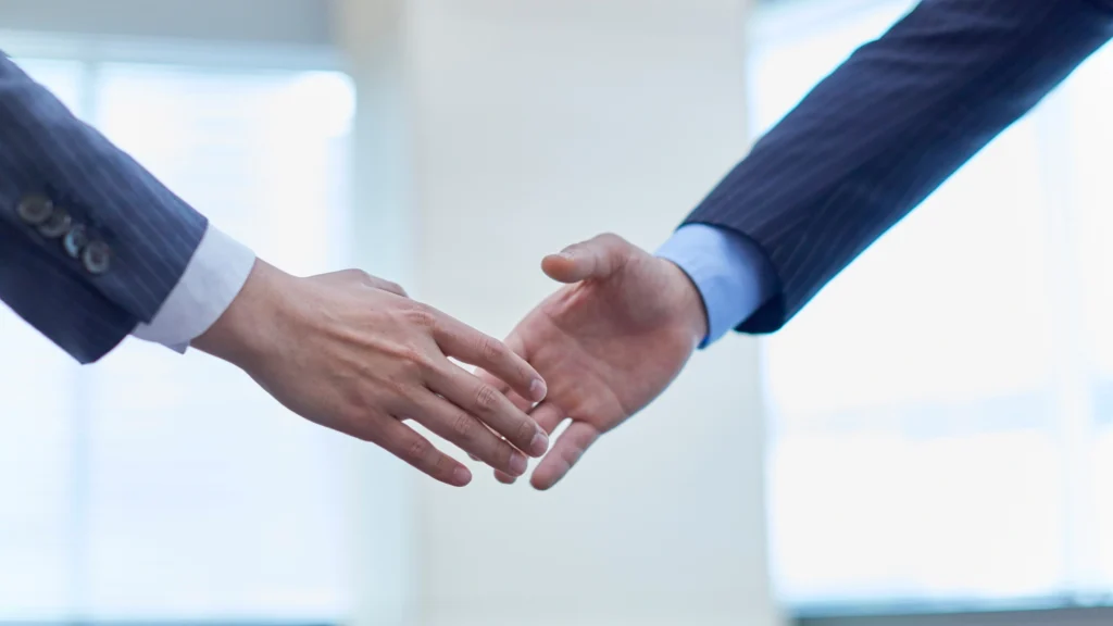 two businessmen about to shake hands with each other