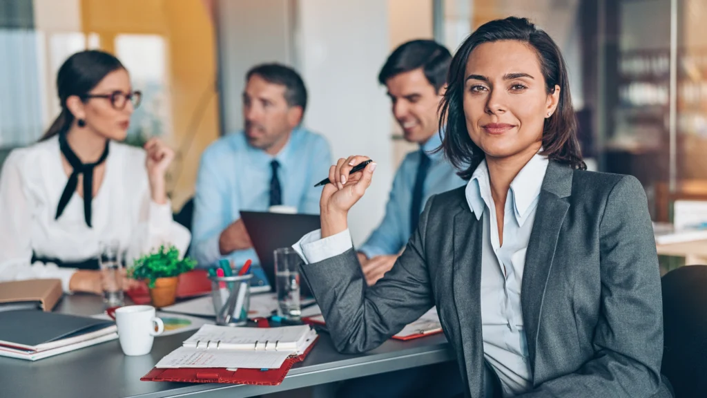 finance managers sitting together around a desk at their workplace
