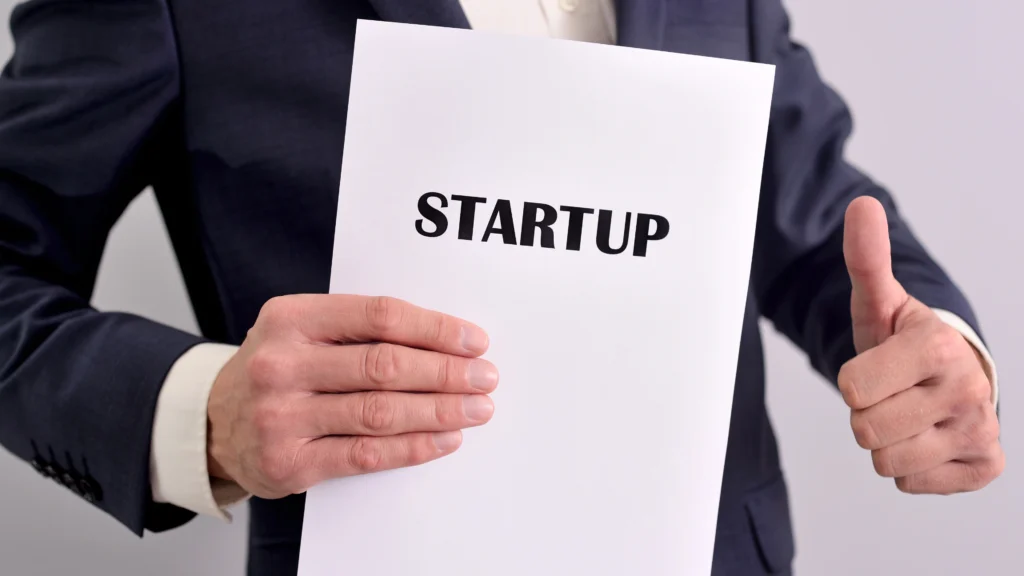 man holding up an important file with documents for his startup