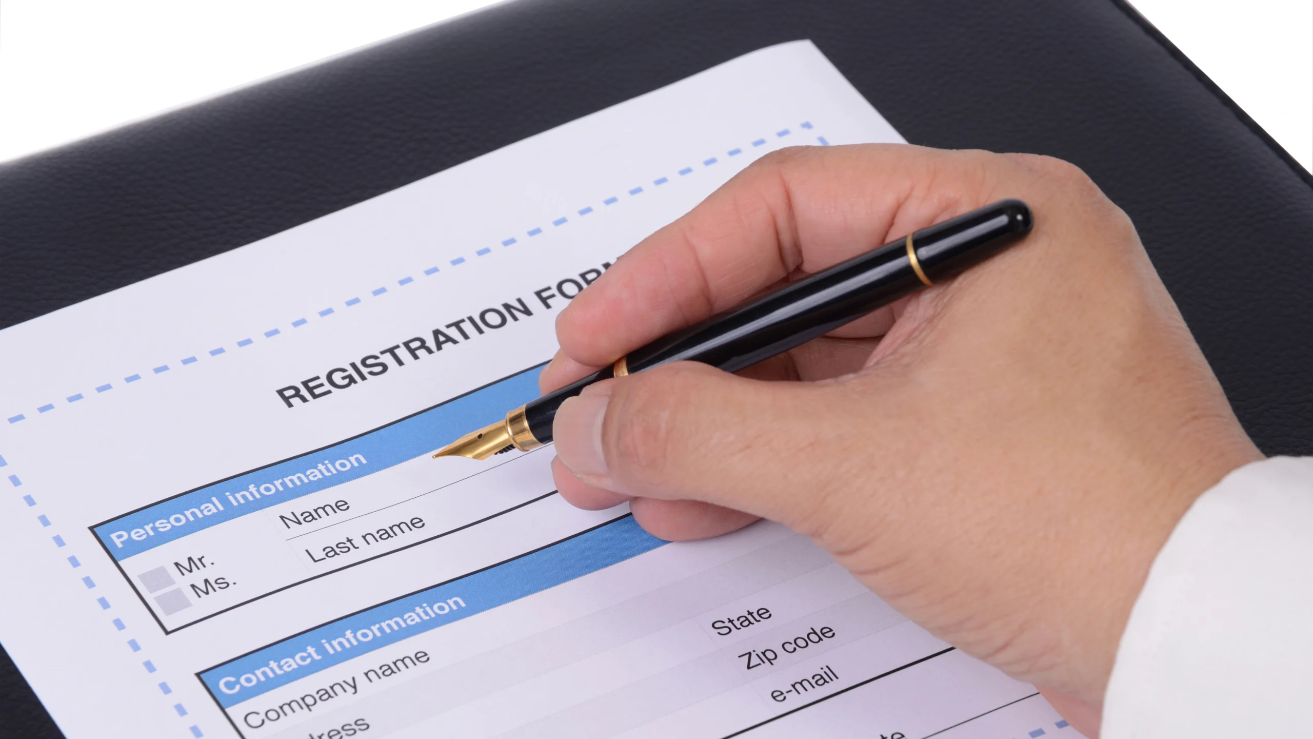 a man filling out a registration form with details