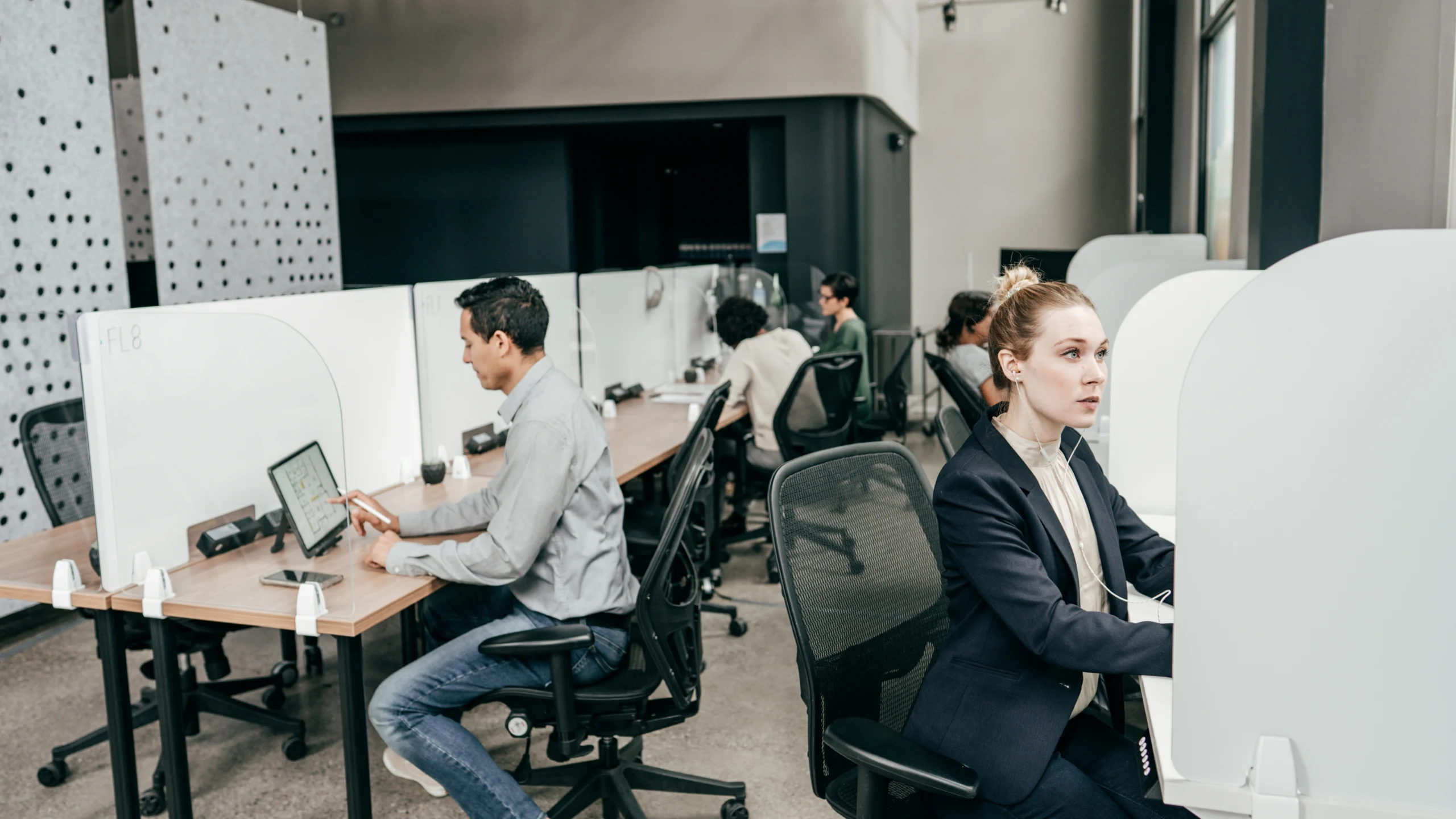 multiple people working at their desks for their company