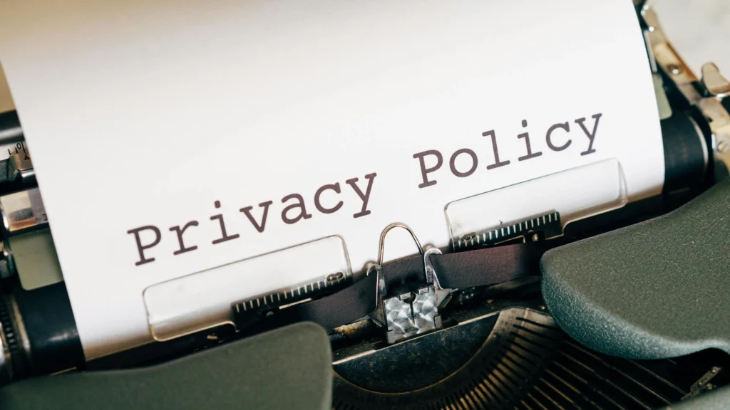 a typewriter with a document being written that says privacy policy