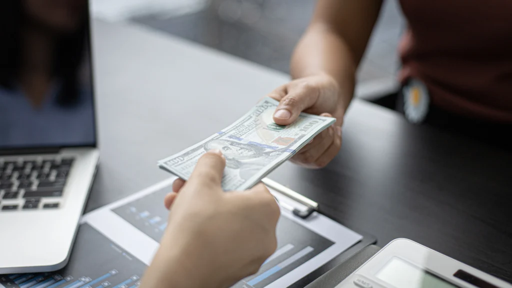 Person handing money to another person