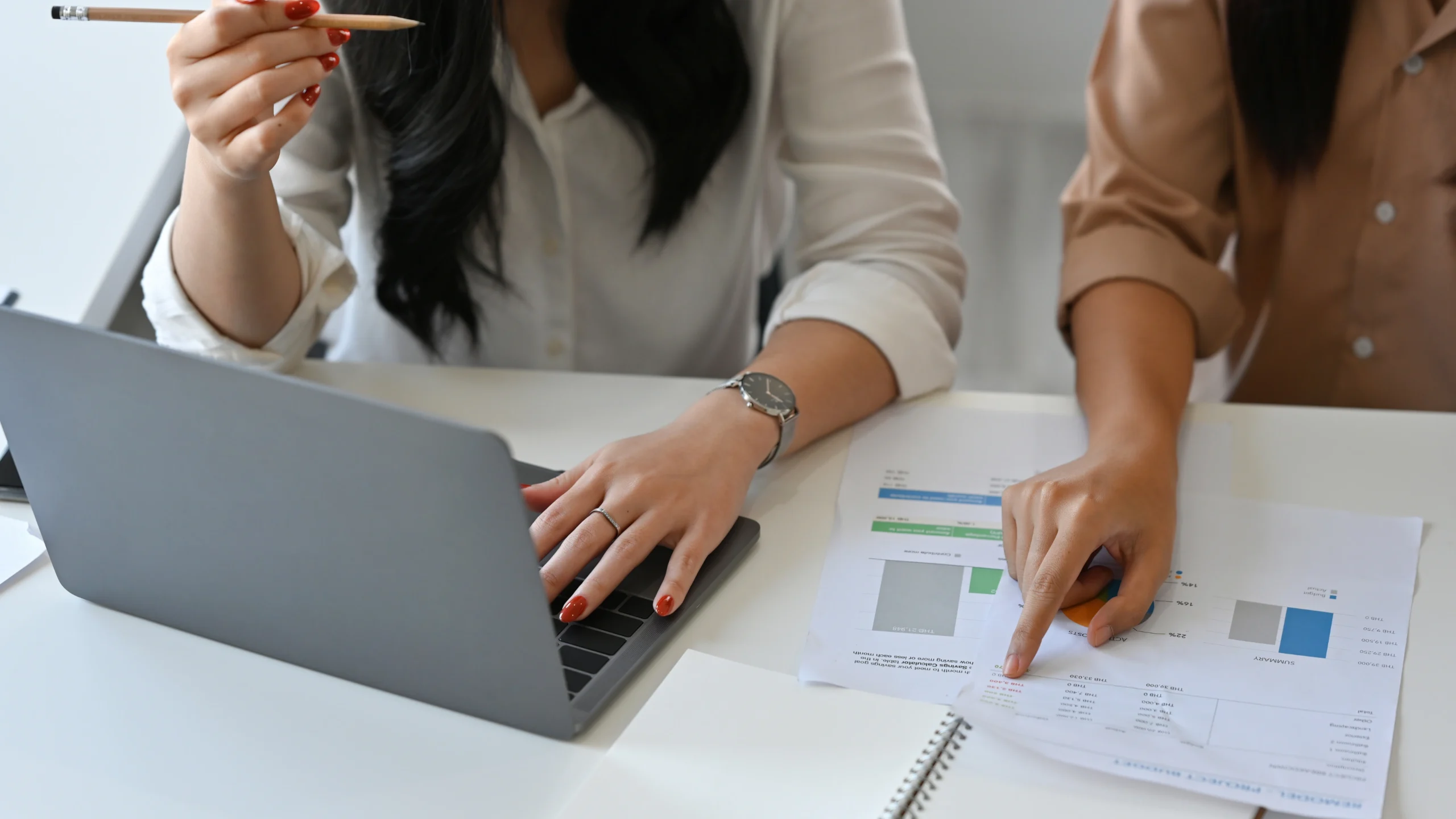 Two woman in the office talking about plans for work