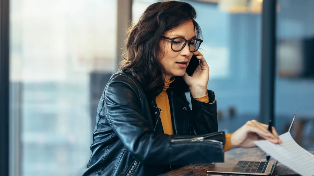 a woman discussing with potential suppliers on a phone call